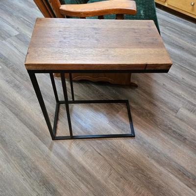 Wooden cane back glider with green cushions - a small table and an antique wooden stool