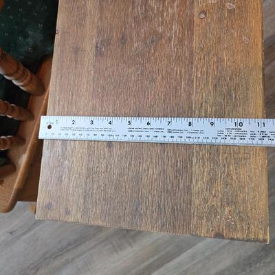 Wooden cane back glider with green cushions - a small table and an antique wooden stool