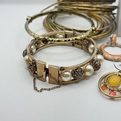 LOT 181: Collection of Bangle Bracelets & Earrings