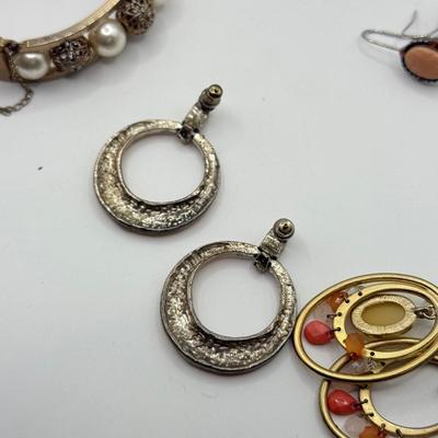 LOT 181: Collection of Bangle Bracelets & Earrings