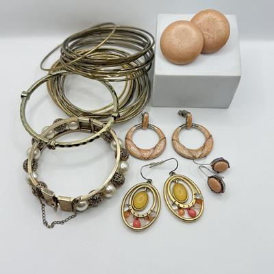 LOT 181: Collection of Bangle Bracelets & Earrings