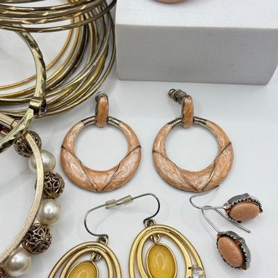 LOT 181: Collection of Bangle Bracelets & Earrings