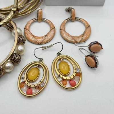 LOT 181: Collection of Bangle Bracelets & Earrings