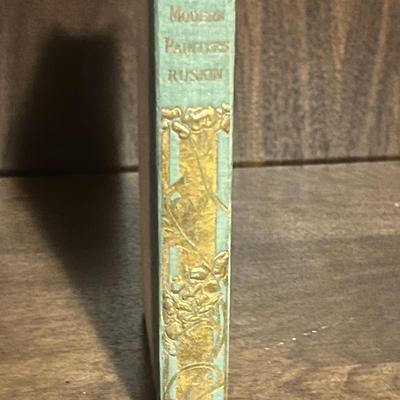 Sale Photo Thumbnail #42: A beautifully produced decorative gift edition of Modern Painters – Selections by influential Victorian art critic John Ruskin. Published by H.M. Caldwell Co., known for ornate turn-of-the-century bindings.

Features include:

Green cloth spine with ela