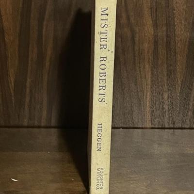 Sale Photo Thumbnail #65: Vintage hardcover copy of Mister Roberts by Thomas Heggen, published in 1946 by Houghton Mifflin. Later printing. Classic WWII naval novel that inspired the Broadway play and 1955 film. Beige cloth boards show visible staining and shelf wear; no dust jack