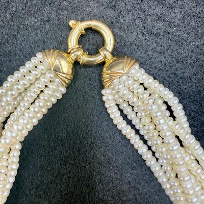 Sale Photo Thumbnail #308: 8-strand freshwater seed pearl necklace with a 14K gold clasp. Clasp is marked "ADPG" and "14K". Overall necklace weight is 55g.  Excellent condition.