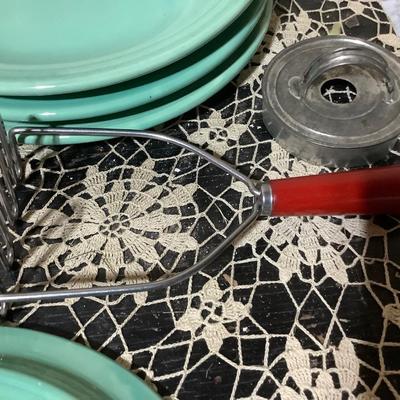 Sale Photo Thumbnail #366: You get 4 divided dinner plates, two hand mashers one red handle the other blue handle.  You also get a black handle hand mixer, and a metal cookie cutter.