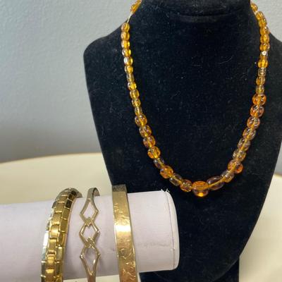 Amber bead necklace and gold tone bracelets
