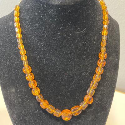 Amber bead necklace and gold tone bracelets