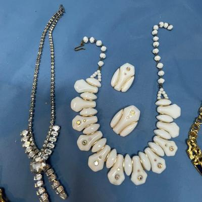 Sale Photo Thumbnail #58: The white set is glass!  The rhinestone necklace has some discoloration.