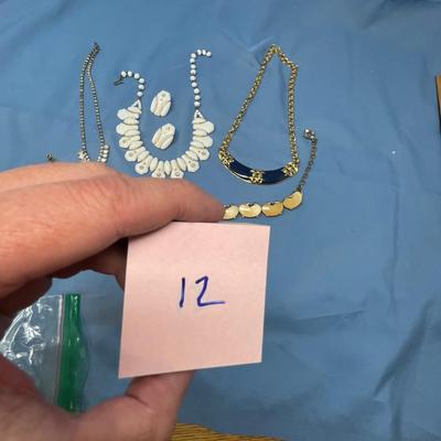 Sale Photo Thumbnail #56: The white set is glass!  The rhinestone necklace has some discoloration.