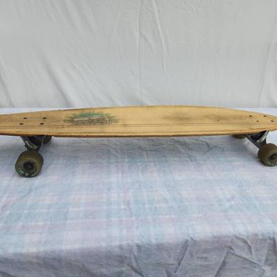 Sale Photo Thumbnail #8: Sector Nine longboard skateboard featuring a wooden deck with a worn graphic design on the underside, painted in green and white with landscape imagery. The board is equipped with trucks and translucent wheels. Some wear is visible on the deck and wheels,