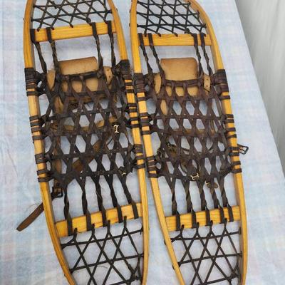 Sale Photo Thumbnail #40: Vintage Sorocraft wooden snowshoes featuring traditional wooden frames and rubberized lacing. Equipped with leather bindings and straps for secure attachment to boots. Made in Canada as indicated on the original labels. Measuring approximately 48 inches i
