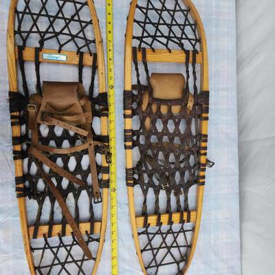 Sale Photo Thumbnail #41: Vintage Sorocraft wooden snowshoes featuring traditional wooden frames and rubberized lacing. Equipped with leather bindings and straps for secure attachment to boots. Made in Canada as indicated on the original labels. Measuring approximately 48 inches i