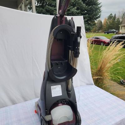 Sale Photo Thumbnail #102: Bissell ProHeat 2X upright carpet cleaner featuring 12 rows of dual DirtLifter power brushes for deep cleaning. Includes a built-in hose and tool storage for accessories. Designed for effective carpet and upholstery cleaning with easy portability. In used