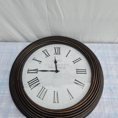 Sale Photo Thumbnail #117: Large round wall clock featuring Roman numeral hour markers and black clock hands on a white face. The clock has a ribbed wooden frame in a dark finish. The face displays the text 'Glasgow, Great George St.' Diameter appears to be around 24 inches, based 