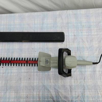 Sale Photo Thumbnail #122: Craftsman 18-inch electric hedge trimmer featuring a durable blade and ergonomic handle. Includes a blade cover for safety. Powered by a standard electrical cord, this trimmer is ideal for light to medium trimming tasks. Condition appears functional with 