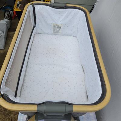 Sale Photo Thumbnail #74: AMKE baby bassinet with a stylish wooden frame and soft mesh siding for breathability and visibility. Includes an accompanying mattress and fitted sheet. Comes with a convenient carrying bag for portability. Designed for stability and easy assembly. Minim