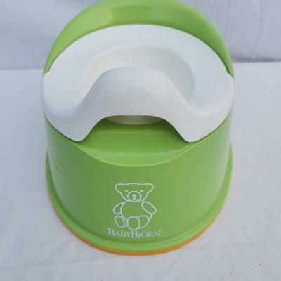 Sale Photo Thumbnail #80: BabyBjorn potty chair in green and white, made from durable, easy-to-clean plastic. Features a removable insert for easy cleaning and a non-slip base for stability. Includes a supportive backrest for added comfort. Designed for toddlers and small children