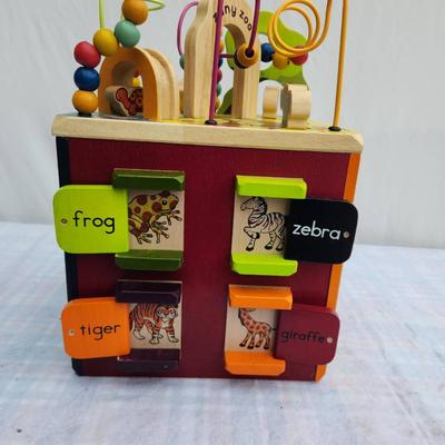 Sale Photo Thumbnail #96: B. Toys Zany Zoo wooden activity cube designed for engaging play. Features bead mazes, spinning alphabet tiles, sliding animal doors, and rotating animal blocks. Made of wood with a multicolor design. Dimensions are not specified. Suitable for toddlers an