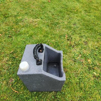 Sale Photo Thumbnail #132: WaterHole EZ-Fill water trough in gray, designed for animals. Constructed from durable, weather-resistant material. Features a sturdy black handle for portability and an integrated white cap for convenient refilling. Suitable for outdoor use in pastures o