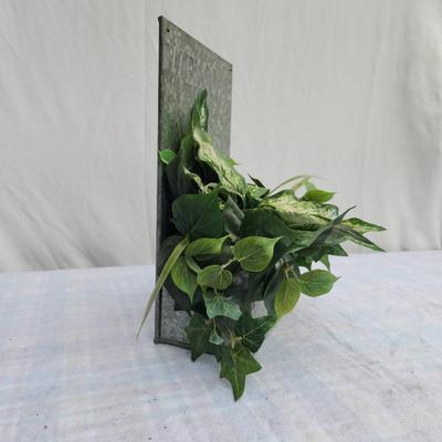 Sale Photo Thumbnail #141: Galvanized metal welcome sign featuring embossed lettering and an attached faux greenery arrangement including ivy and variegated leaves. The sign includes a brass-tone label holder on the front for easy personalization. Suitable for indoor or covered out
