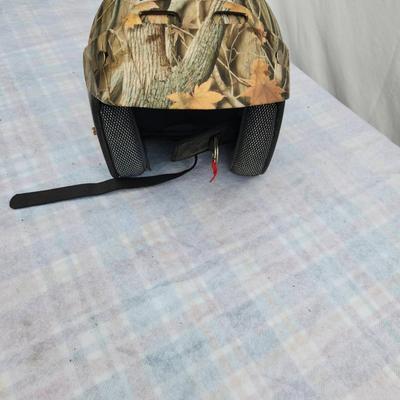 Sale Photo Thumbnail #143: AFX half helmet featuring a camouflage pattern with autumn leaves. Includes an adjustable chin strap with quick-release buckle for secure fitting. Lightweight and designed for safety with padding along the edge. Ideal for outdoor enthusiasts and motorcycl