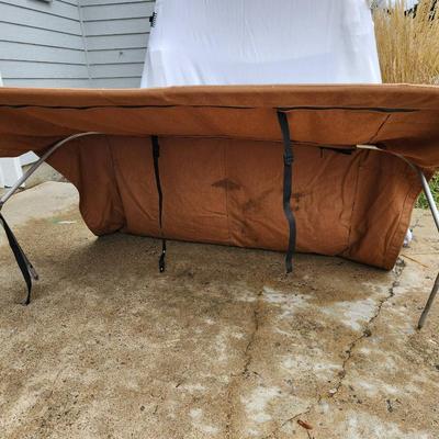 Sale Photo Thumbnail #152: Boat bimini top featuring a durable aluminum frame and fabric cover in a brown color. The structure includes straps for securing the bimini. The measurements indicate it spans approximately 60 inches wide, suitable for most small to medium-sized boats. So