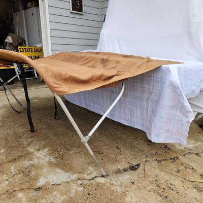 Sale Photo Thumbnail #150: Boat bimini top featuring a durable aluminum frame and fabric cover in a brown color. The structure includes straps for securing the bimini. The measurements indicate it spans approximately 60 inches wide, suitable for most small to medium-sized boats. So