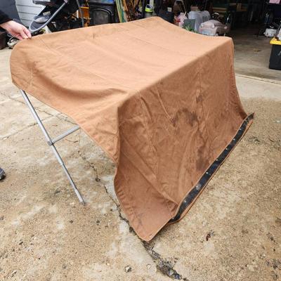 Sale Photo Thumbnail #153: Boat bimini top featuring a durable aluminum frame and fabric cover in a brown color. The structure includes straps for securing the bimini. The measurements indicate it spans approximately 60 inches wide, suitable for most small to medium-sized boats. So