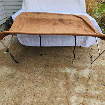 Sale Photo Thumbnail #151: Boat bimini top featuring a durable aluminum frame and fabric cover in a brown color. The structure includes straps for securing the bimini. The measurements indicate it spans approximately 60 inches wide, suitable for most small to medium-sized boats. So