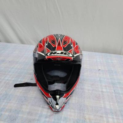 Sale Photo Thumbnail #164: HJC CL-X4 off-road motorcycle helmet in red and black with distinct graphic design. Size XL. The helmet features a durable shell, adjustable visor, and a comfortable inner lining. It is suitable for off-road and motocross use. Signs of light use may be pr