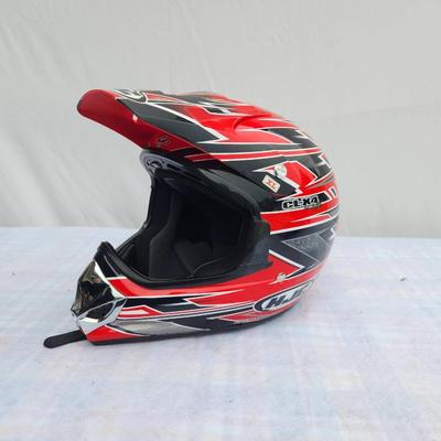 Sale Photo Thumbnail #163: HJC CL-X4 off-road motorcycle helmet in red and black with distinct graphic design. Size XL. The helmet features a durable shell, adjustable visor, and a comfortable inner lining. It is suitable for off-road and motocross use. Signs of light use may be pr