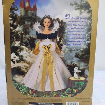 Sale Photo Thumbnail #17: Disney Holiday Princess Snow White doll from the 1997 series, sealed in the original packaging. The doll features Snow White in an elaborate gown with gold and white accents, reflecting a festive holiday theme. The packaging shows some wear but remains in