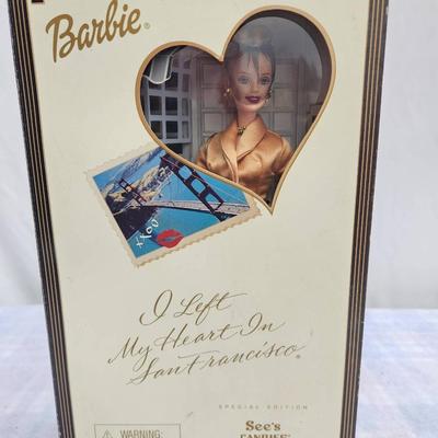 Sale Photo Thumbnail #23: Special Edition Barbie doll titled 'I Left My Heart in San Francisco,' produced in collaboration with See's Candies. The doll is presented in a themed packaging featuring classic San Francisco elements and a See's Candies storefront. Includes elegant atti