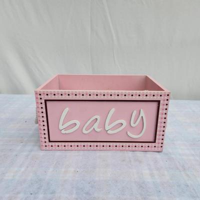 Sale Photo Thumbnail #83: Pink wooden storage box featuring a decorative 'baby' sign in white lettering and a polka dot border. Includes white rope handles for easy carrying. Comes with baby care items including an American Red Cross bulb syringe and nasal aspirator. Practical for
