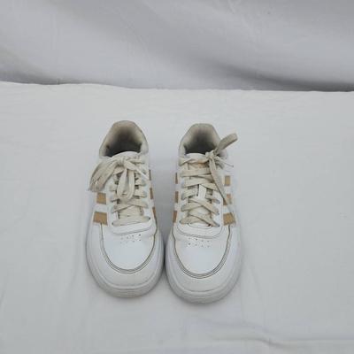 Sale Photo Thumbnail #174: Adidas women's athletic sneakers in white with gold accents. Made in Indonesia, these shoes are labeled as size 5.5 US (EU 36, UK 4, JP 225). Features include a lace-up closure, synthetic materials, and a padded insole for comfort. Good pre-owned conditio