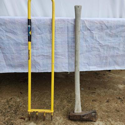 Sale Photo Thumbnail #185: A heavy-duty garden fork with a bright yellow steel handle, designed for durability and efficient soil cultivation, and a sledgehammer featuring a concrete or wrapped handle with a robust steel head suitable for heavy-duty demolition tasks. Both items sho