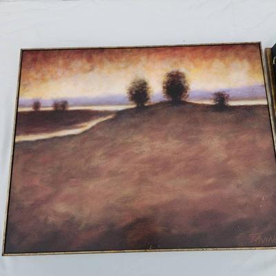 Sale Photo Thumbnail #192: Landscape paintings by artist Taino, depicting sunset scenes with trees in the foreground. Each painting is completed in warm, earthy tones and framed with simple gold-colored frames. Both are signed 'Taino' in the lower left-hand corner. The paintings ar