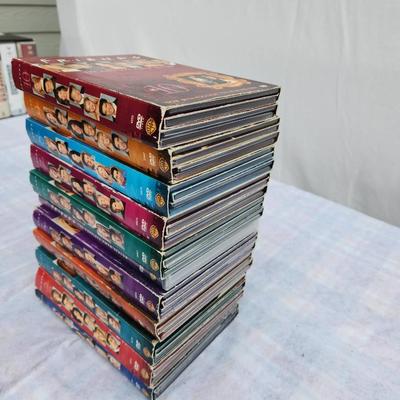 Sale Photo Thumbnail #201: Complete DVD box set of the television series 'Friends' featuring all 10 seasons. Each season is contained in its own multi-disc case with color-coded spine art showcasing cast photos. All cases appear intact, and discs are presumed in playable condition.