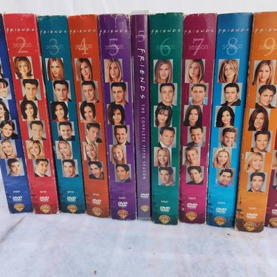 Sale Photo Thumbnail #200: Complete DVD box set of the television series 'Friends' featuring all 10 seasons. Each season is contained in its own multi-disc case with color-coded spine art showcasing cast photos. All cases appear intact, and discs are presumed in playable condition.