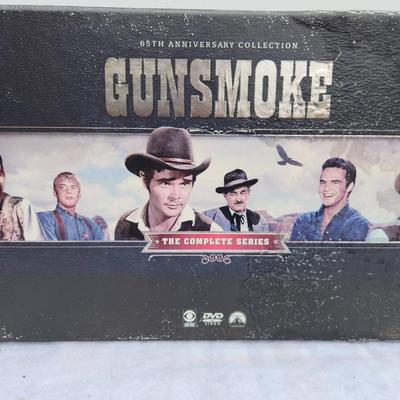 Sale Photo Thumbnail #205: Gunsmoke 65th Anniversary Collection, featuring the complete series on DVD. The set includes a boxed collection with multiple DVDs across multiple cases, showcasing iconic artwork related to the series. Packed with timeless episodes, this set is a must-ha