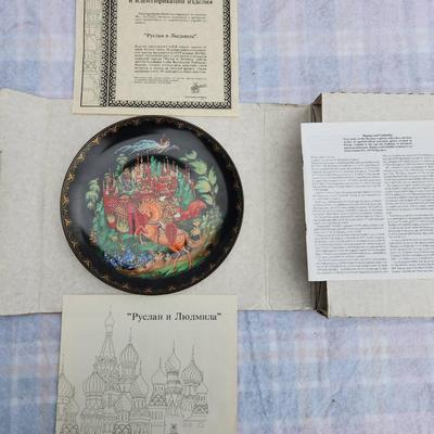 Sale Photo Thumbnail #215: Russian hand-painted lacquerware plate featuring a vibrant fairy tale scene with a horse and castle motif. The reverse side includes inscriptions in Cyrillic detailing the plate's origins and theme. Accompanied by documentation, illustrations, and origina