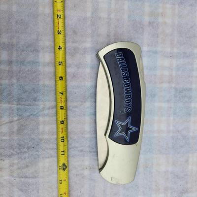 Sale Photo Thumbnail #229: Dallas Cowboys folding knife featuring a white handle with a decorative star emblem and the team's name in blue. The blade is stainless steel, and the knife measures approximately 8 inches when open and about 4.5 inches when folded. The item includes a de