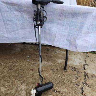 Sale Photo Thumbnail #260: Minn Kota 10 electric trolling motor featuring a single propeller with a durable plastic blade. Includes a handle for control, along with a functional speed and direction switch. Unit connects to a 12V power source with attached cables. Requires testing f