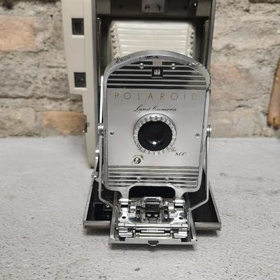 Sale Photo Thumbnail #480: Polaroid 800 in case with books and flash attachments. Fits large flat rate box