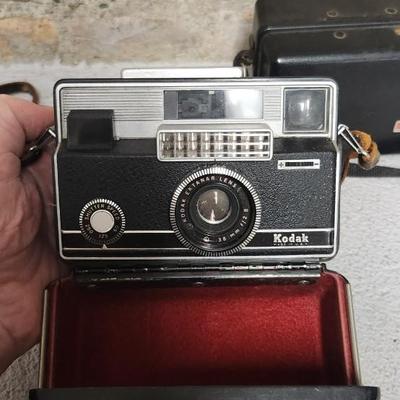 Sale Photo Thumbnail #638: Pair of Kodak Instamatic cameras. One 700 in case and one x-30 in case. The 700 has film in it. Fits medium flat rate box