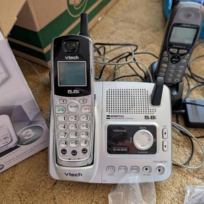 Large group of phones and bases, and answering machine.