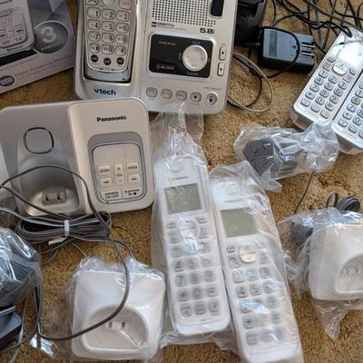 Large group of phones and bases, and answering machine.