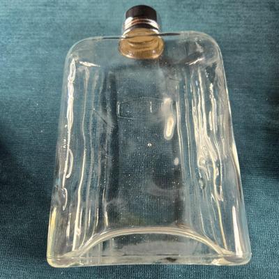 Sale Photo Thumbnail #488: This auction lot is for a Vintage Flask with Faux Leather Case. This is a useful and handsome Flask with Faux Leather Case.  The flask itself is glass and marked TRC.  The case shows wear on the black edging.  Overall in good condition.
